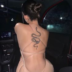 a woman with a snake tattoo on her back