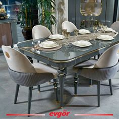 a dining room table set with white plates and silverware on it, surrounded by beige chairs