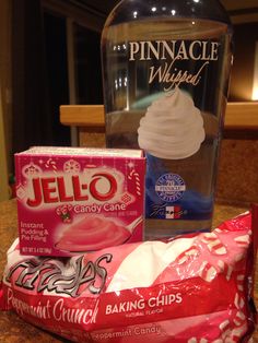 a bottle of water and some snacks on a counter next to a bag of chips