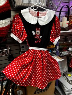 a minnie mouse dress on display in a store