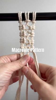 someone crocheting the end of a piece of white yarn with two hands holding it