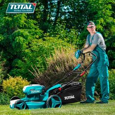 a man mowing the grass with a lawnmower in front of some bushes