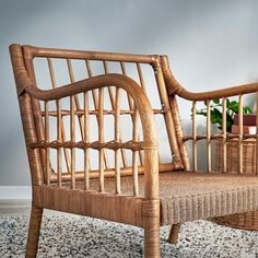 a wicker chair sitting on top of a rug