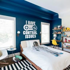 a bedroom decorated in blue and white with a large snowboard painted on the wall