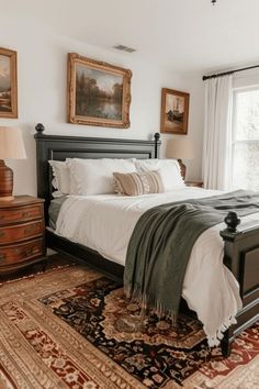 a bedroom with a bed, dressers and pictures on the wall