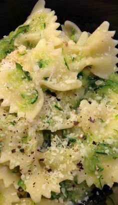 pasta with broccoli and parmesan cheese in a black bowl