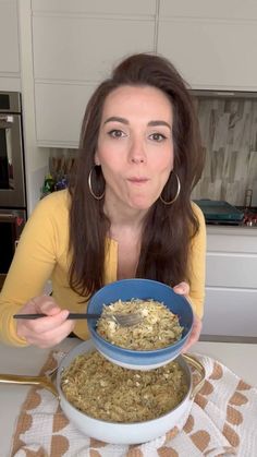 a woman sitting at a table with a bowl of food