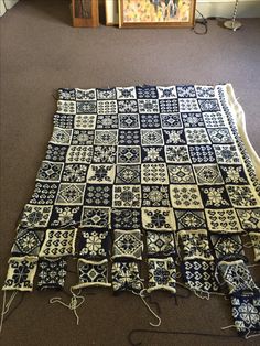 a blue and white blanket laying on the floor