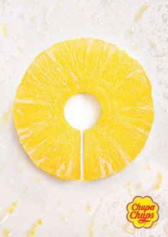 a sliced pineapple sitting on top of a white counter next to a yellow stick