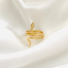 ⭐️Item Details: Ring Height: 25mm Material: 18k Gold Filled Benefits: Water & Tarnish Resistant, Hypoallergenic, Lightweight ⭐️Care Instructions: 1. You may shower and sleep with your gold filled items but it is highly suggested to avoid direct contact with pools, hot tubs, and saltwater. 2. Avoid the jewelry to come into contact with perfume, lotions or any other cosmetic products. 3. Rinse jewelry in warm water at least once a week and gently dry it with a soft cotton cloth to ensure durabilit Adjustable Gold Snake Ring Gift, Adjustable Gold Snake Ring Symbolic, Adjustable Gold Symbolic Snake Ring, Gold Plated Snake Ring Gift, Gold Snake Ring As Gift, Gold Minimalist Snake Ring For Gift, Gold Minimalist Snake Ring, Gold Plated Snake Ring As A Gift, Gold Snake-shaped Ring For Anniversary