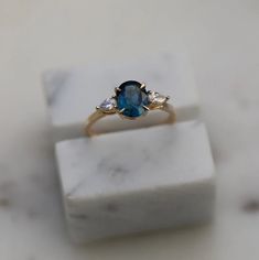 a blue ring sitting on top of a marble block