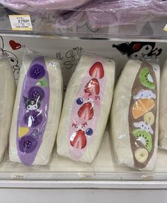 there are four different types of breads on display in the store's case