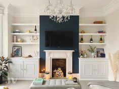 a living room filled with furniture and a flat screen tv mounted on the wall above a fireplace