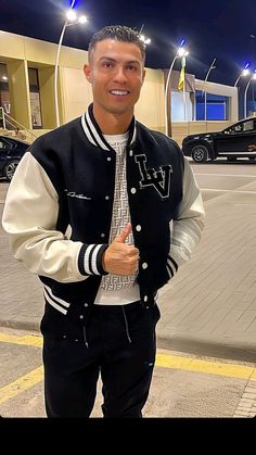 a man wearing a jacket and tie standing next to a parking lot