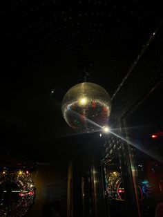 a disco ball hanging from the ceiling in a dark room