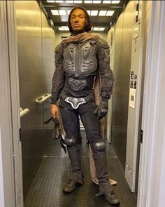 a man dressed in armor standing in an elevator