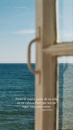 an open window overlooking the ocean with a sailboat in the distance and a quote written on it