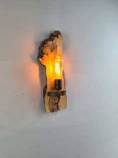 a light that is on the side of a wall with a candle in it's holder