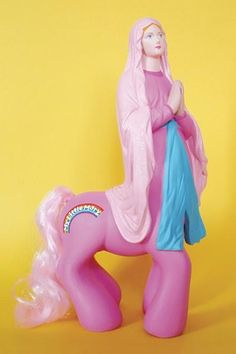 a pink toy horse with a woman on it's back