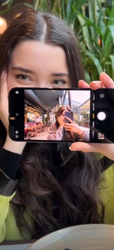 a woman taking a selfie with her cell phone