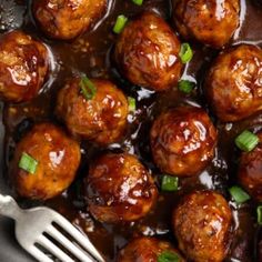 meatballs with sauce and green onions in a skillet, ready to be eaten