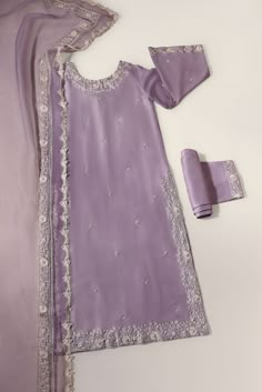 Curated on soft pure raw silk 60 gms in an enchanting Lilac hue, with intricate creamy threadwork alongside clusters of hand sewn pearls and pretty laces. The dupatta is adorned with signature embroidered laces, styled with flappers for a head turning look. The length of the long kameez is 47 inches. Order Duration: 4 Kameez Ideas, Long Kameez, Beautiful Pakistani Dresses, Desi Fashion Casual, Dress Design Patterns, Stylish Party Dresses, Boutique Dress Designs, Designer Dresses Casual, Fancy Dress Design