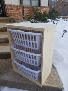 three baskets are stacked on top of each other outside in the snow