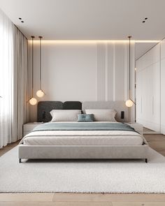 a modern bedroom with white walls and wood flooring, along with a large bed