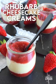 two jars filled with cheesecake creams and strawberries on the table next to each other