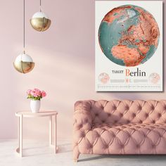 a living room with a pink couch and poster on the wall