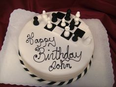 a birthday cake with chess pieces on it