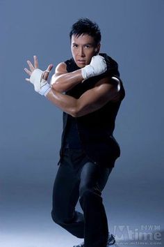 a man in black shirt holding a white glove