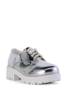 The AZALEA WANG Pierrette Silver Flatform Clog is a reflective metallic stunner that features a faux patent leather upper, a round toe silhouette, a Comfort Cushion insole, a contrast short chunky heel, and a coordinating platform sole. Complete with tonal stitching, a textured outsole, a pull-on fit, and a contrast lace-up vamp.   (all measurements are approximate from size 7.5) - Metallic Faux Leather Upper - Round Toe - Comfort Cushion Insole - Chunky Heel - Platform Sole - 1.75” Heel Height - 1” Sole Height  - Imported  Product ID: 425063 Azalea Wang, Silver Flats, Platform Heels Chunky, Chunky Heel, Chunky Heels, Patent Leather, Clogs, Heel Height, Leather Upper