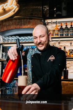 a man pouring a drink at a bar