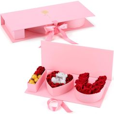 two pink boxes with red roses in them and a white teddy bear sitting inside one