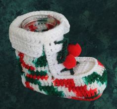 a crocheted christmas stocking with a red pom - pom on it