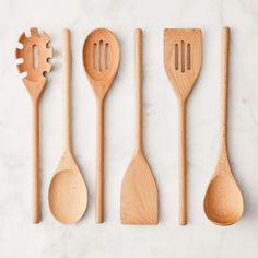 wooden utensils lined up on a marble surface