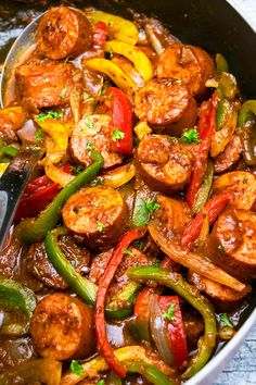 slow cooker sausage and peppers in a skillet with the words slow cooker sausage and peppers