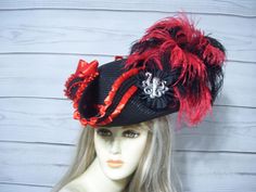 Beautiful black nice quality faux straw pirate hat with red peated trim, black braid, two red stain bows, black pinwheel with a metal octopus accent and black and red ostrich feathers. Please measure your head, this hat is 22.5" for the inside circumference with a built-in hat sizer. Just cinch and tie. I cannot make the circumference bigger. Check out my other pirate hats and other goodies in my etsy shop. Thank you for stopping by. Have a great day. I ship Priority mail. I ship many times a week. If you need your item quicker let me know your zip code and I can figure shipping rates for you. Please let me know if you have any questions All sales are FINAL, no returns or exchanges please keep this in mind before purchasing. International buyers: Please know that you will be held responsib Red Costume Hat, Red Hats For Carnival Costume Party, Red Adjustable Hat For Costume Party, Adjustable Red Hat For Costume Party, Red Brimmed Hat For Costume, Red Costume Hats For Carnival, Red Themed Hat For Costume Party, Black Pirate Costume Hat With Curved Brim, Adjustable Pirate Hat For Party