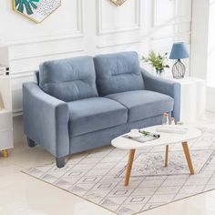 a living room with two blue couches and a coffee table in front of it