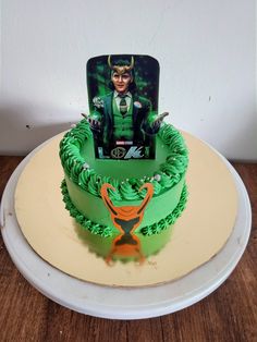 there is a green cake with an image of loki on the front and back of it