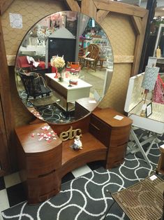 a mirror sitting on top of a wooden dresser