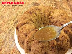 an apple cake on a white plate with a spoon in it and caramel sauce