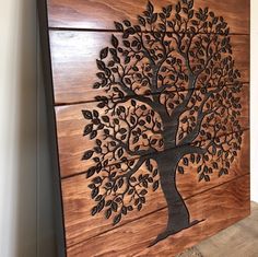 a wooden wall hanging with a tree on it