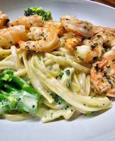 pasta with shrimp and broccoli on a white plate