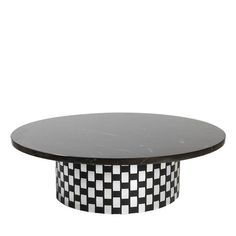 a round table with black and white checkerboard pattern on the top, against a white background