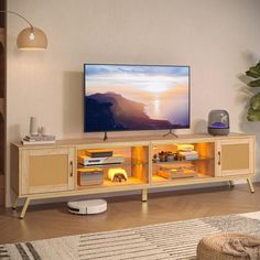 a flat screen tv sitting on top of a wooden entertainment center in a living room