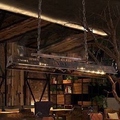 the interior of a restaurant with wooden tables and chairs, hanging from chains on the ceiling