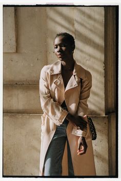 Introducing our summer essential - the beige silk trench coat. This soft and lightweight overcoat is perfect for the warmer months and will elevate any outfit. Made of vegan silk, this long double-breasted trench coat is not only stylish but also sustainable. Its neutral beige color makes it easy to style with any outfit, adding a touch of elegance to your wardrobe. Upgrade your spring and summer wardrobe with this must-have beige silk trench coat. Features a notched collar, a double-breasted fr Belted Long Pea Coat For Spring, Beige Notch Lapel Pea Coat For Spring, Spring Beige Pea Coat With Notch Lapel, Cream Lapel Collar Pea Coat For Spring, Spring Belted Pea Coat With Lapel Collar, Cream Pea Coat With Lapel Collar For Spring, Beige Pea Coat With Lapel Collar For Spring, Spring Belted Pea Coat, Belted Beige Pea Coat For Spring