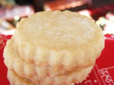 three cookies sitting on top of a red plate